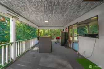 Spacious covered porch area offering plenty of room to design your ideal outdoor dining or lounge setup. This inviting space is perfect for entertaining guests, enjoying fresh air meals, or relaxing while surrounded by the beauty of the outdoors.