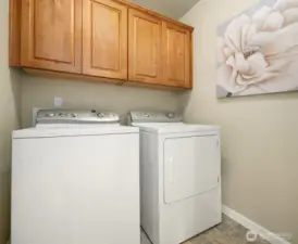 Laundry room with cabinet storage.