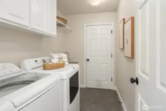 Functional main-floor laundry room offering direct garage entry.