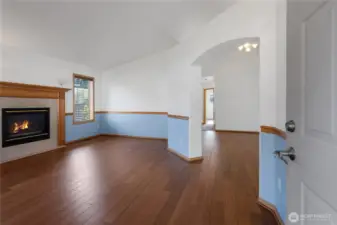 Living room with sold flooring, gas fireplace