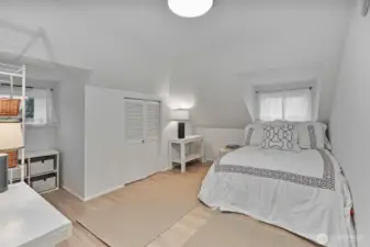 Bright, roomy bedroom that fits a queen bed with ease.