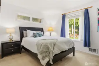 Primary bedroom looks out the peaceful back yard