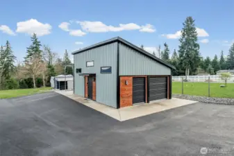 Look at this detached 4 car garage/shop and currently a partial party cave! Small kitchenette, heat and TV for so much fun!  There is a carport on the other side!