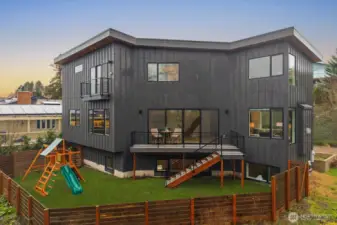 Modern exterior with expansive back deck and fully fenced yard