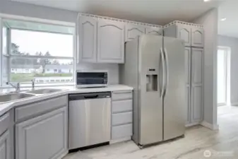 Updated kitchen with modern finishes, cabinets, and stainless steel appliances.