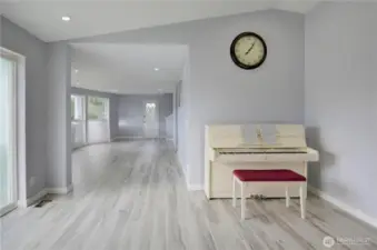 Bright and spacious main floor living area featuring updated flooring, soft neutral finishes, and an open, flowing layout