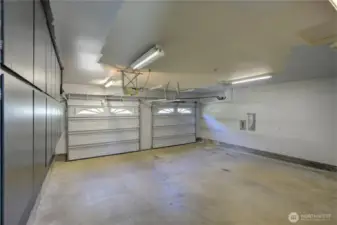 The spacious two-car garage is a storage dream, featuring an abundance of built-in cabinets, shelving, and storage solutions that keep everything organized and within reach — perfect for tools, hobbies, and all the extras that come with everyday living.