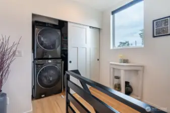 Custom California Closet next to the full size stackable washer/dryer