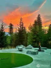 Sunken fire pit with shaved boulder benches.
