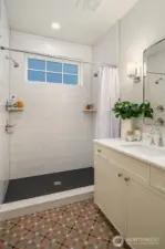 The main floor bath is graced by patterned Italian tile heated flooring and a large custom walk in shower.