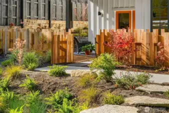 The home overlooks lushly planted common area gardens featuring fruiting and flowering plantings.  Blueberries anyone?