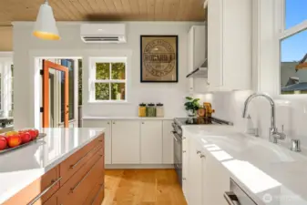 The kitchen looks over and steps out to the upper level dining terrace.  Dining al fresco anyone?