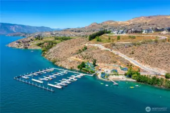 Aerial view of the Lookout's private marina and waterfront park area with sandy beach cove.