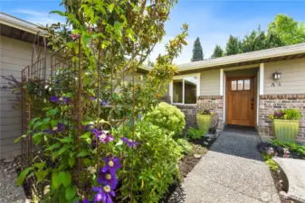 Welcome home to this beautifully landscaped entryway that sets the tone for warmth and charm.