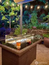 This enchanting backyard patio offers the perfect setting for evening relaxation