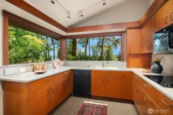 Conveniently located off the formal living area, the kitchen features generous storage and a spacious walk-in pantry for effortless organization.