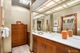 The primary suite includes an expansive bathroom with a step-in shower, dual vanities, two built-in dresser storage areas, and two walk-in closets—all crafted from high-quality wood.