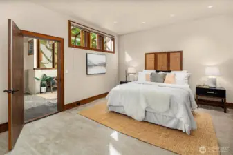 The light-filled solarium is full of charm, with access through three doors—connecting to the adjacent bedroom, the library, and the backyard.