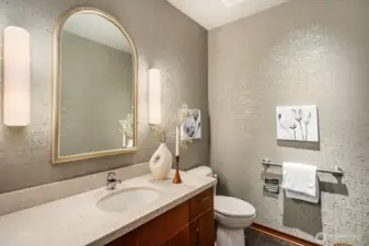 The main-floor bathroom exudes elegance, featuring solid wood cabinetry and refined finishes.
