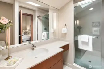 Bedroom #4 is also an en suite, featuring a private bathroom with a convenient step-in shower.