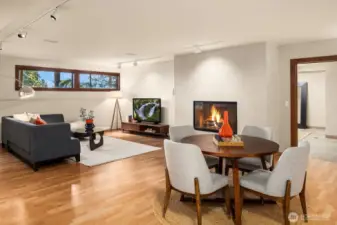 The daylight basement offers a cozy gas fireplace and plenty of space for TV, media, and game nights.