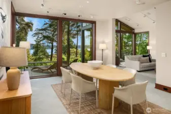 The dining room comfortably seats 12 or more and includes a wet bar along the back wall. With a sunset view and filtered light, it's perfect for entertaining.