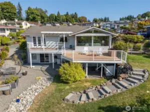 Expansive deck with glass railing for unobstructed views up top, and covered patio below.