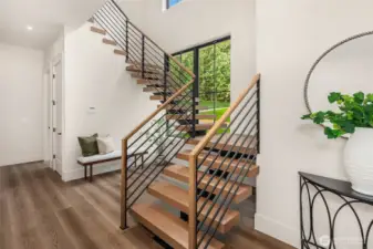 custom modern staircase with catwalk on second floor.