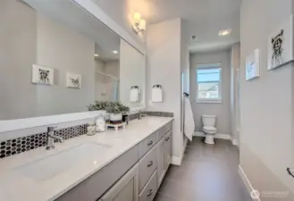 Full bathroom with double sinks & tub shower