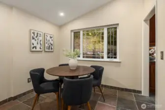 Breakfast nook adjoins kitchen and family room, with beautiful windows looking out on nature.
