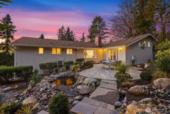 Serene and private back garden with terrace and waterfall.
