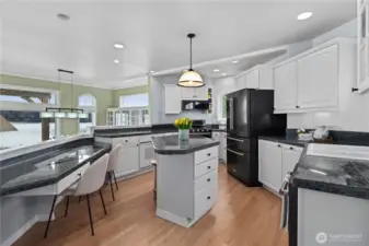 Designed for both function and connection, this open kitchen offers ample prep space, island seating, and beautiful sightlines to the water.