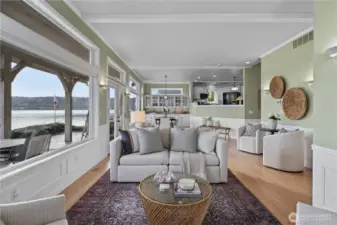 Expansive great room with walls of windows capturing stunning waterfront views and seamless flow to the dining area and kitchen.