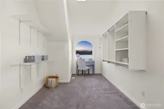 A true retreat, this oversized walk-in closet features thoughtfully designed storage and stunning waterfront views, blending everyday function with elevated luxury.