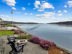 Private waterfront with firepit seating, offering sweeping views and a tranquil outdoor experience.
