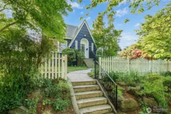 White picket fence frames the front exterior for a period look