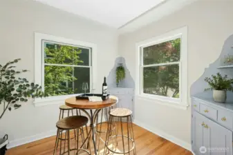 Dining nook with original built-in corner cupboards.
