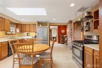 The eat-in kitchen is so light and bright with the large skylight above the table.