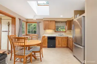 Another view showing the spacious kitchen with the operable skylight above the dining table.