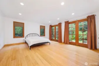 The primary bedroom is at the end of a hall on the back side of the home and opens to its own deck. The room is very spacious and looks to the very old apple tree and large yard.