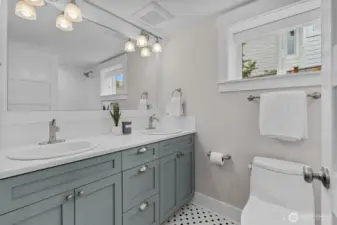 The lower-level bathroom showcases thoughtful details and stylish touches, including modern fixtures, elegant tile work, and a clean, bright design.