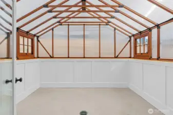 Light and bright interior sunroom or greenhouse—an inviting space to relax, grow, or create year-round.