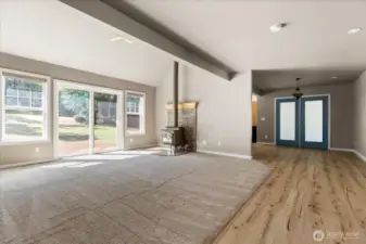 Living room with wood burning fireplace and slider to back deck
