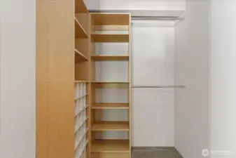 Primary walk in closet with built ins