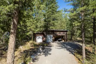 The garage is tucked towards the back of the lot with room to expand or build in front.