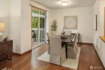 The dining area is large enough to accommodate a full-sized dining room table with comfortable seating for six. The slider opens to the serene private covered deck