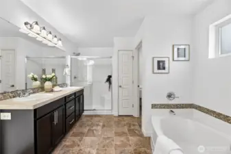 Ensuite Bathroom off Primary features a seperate soaking tub, stand up shower, double vanity and throne room.