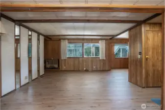 Generous windows bring in natural light and connect the space to the surrounding outdoor setting.