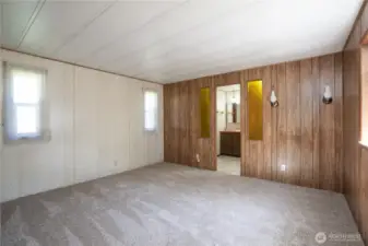 Spacious bedroom with natural light and ample wall space, offering flexibility for furniture and layout options. Convenient access to the adjacent bathroom adds functionality and everyday comfort.