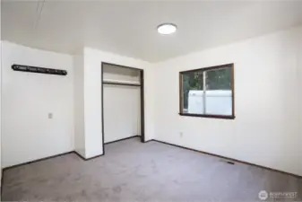 Comfortable bedroom featuring natural light and a spacious closet with built-in shelving for added storage. Functional layout provides flexibility for everyday living or guest use.    Bathroom featuring a functional layout with vanity storage and a tub/shower combination. Natural light and warm finishes create a comfortable and practical space for everyday use.    Versatile flex space filled with natural light, ideal for a home office, reading room, or additional living area. Large windows provide views of the surrounding property while enhancing the open, airy feel.